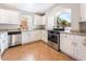 Bright kitchen with white cabinets, stainless steel appliances, and granite countertops at 10993 Ladyburn Ct, Las Vegas, NV 89141