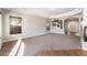 Large living room featuring a fireplace, a tray ceiling, and access to the entryway at 10993 Ladyburn Ct, Las Vegas, NV 89141