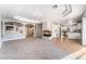 Bright living room with carpet, a fireplace, stairs, and a view of the kitchen at 10993 Ladyburn Ct, Las Vegas, NV 89141