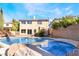 Backyard features a pool and hot tub with rock features, offering a luxurious and relaxing outdoor experience at 10993 Ladyburn Ct, Las Vegas, NV 89141