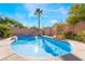 Sparkling pool with rock features and clear blue water offers a refreshing escape in a private backyard setting at 10993 Ladyburn Ct, Las Vegas, NV 89141