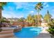 Gorgeous pool and spa with rock waterfall feature nestled within a private, lush backyard retreat at 10993 Ladyburn Ct, Las Vegas, NV 89141