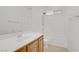 Clean bathroom with a white tile shower-tub combo, wood vanity and sink at 11247 Villa Trentino Ct, Las Vegas, NV 89141