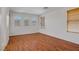 Spacious bedroom with three arched windows and wood flooring at 11247 Villa Trentino Ct, Las Vegas, NV 89141