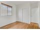 Bright bedroom features wood floors, a window with blinds, and closet for ample storage at 11247 Villa Trentino Ct, Las Vegas, NV 89141