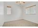 The bedroom has neutral carpet, ceiling fan and good natural light from two windows at 11247 Villa Trentino Ct, Las Vegas, NV 89141