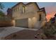Charming two-story home featuring a private entrance, two-car garage, and desert landscaping at 11247 Villa Trentino Ct, Las Vegas, NV 89141