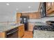 Updated kitchen featuring granite countertops and black appliances at 11247 Villa Trentino Ct, Las Vegas, NV 89141