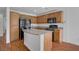 Functional kitchen featuring an island, granite countertops, and modern appliances at 11247 Villa Trentino Ct, Las Vegas, NV 89141