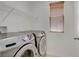 The functional laundry room features a modern Samsung washer and dryer and shelving at 11247 Villa Trentino Ct, Las Vegas, NV 89141