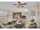 Bright, virtually staged living room with plush seating, and an open concept to the kitchen at 11247 Villa Trentino Ct, Las Vegas, NV 89141