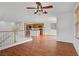 Open-concept living room with hardwood floors, white walls, and views of the kitchen at 11247 Villa Trentino Ct, Las Vegas, NV 89141
