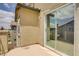 A sun-drenched balcony features stucco walls, railings, and sliding glass doors at 11247 Villa Trentino Ct, Las Vegas, NV 89141