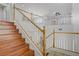 Staircase leading to the second floor with wood steps and white railing at 11247 Villa Trentino Ct, Las Vegas, NV 89141