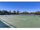 Outdoor tennis court with well-maintained green surface and clear blue sky above at 11247 Villa Trentino Ct, Las Vegas, NV 89141