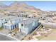 Aerial view of a modern two-story home in a desert community with mountain views and desert landscaping at 11800 Black Canary Ave, Las Vegas, NV 89138