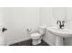 This powder room features pedestal sink, dark fixtures, and a modern design at 11800 Black Canary Ave, Las Vegas, NV 89138
