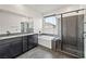 Modern bathroom features dual vanities, soaking tub, a glass-enclosed shower, and mountain view window at 11800 Black Canary Ave, Las Vegas, NV 89138