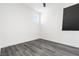 Modern bedroom with hardwood floors, minimalist design, and stylish ceiling fan and window shade at 11800 Black Canary Ave, Las Vegas, NV 89138