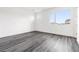 Spacious bedroom features sleek hardwood floors, a bright, minimalist design, and large windows at 11800 Black Canary Ave, Las Vegas, NV 89138