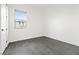 Bright bedroom featuring neutral walls, gray tile flooring and a window at 11800 Black Canary Ave, Las Vegas, NV 89138