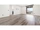 Spacious bedroom with wood-look floors and access to the balcony at 11800 Black Canary Ave, Las Vegas, NV 89138
