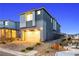 Modern two-story home at dusk featuring a two-car garage, neutral paint, and desert landscaping at 11800 Black Canary Ave, Las Vegas, NV 89138