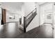 Open foyer with dark tile flooring, a staircase with metal railing, and views of the living area at 11800 Black Canary Ave, Las Vegas, NV 89138