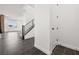 Foyer with dark tile flooring, white walls, a staircase with metal railing, and access to a living area at 11800 Black Canary Ave, Las Vegas, NV 89138