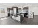 Kitchen with black cabinetry, stainless steel appliances, and modern island at 11800 Black Canary Ave, Las Vegas, NV 89138