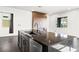 Stylish kitchen island with dark countertop, sink, and stainless steel dishwasher at 11800 Black Canary Ave, Las Vegas, NV 89138