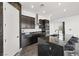 Modern kitchen with center island and bar stool seating area at 11800 Black Canary Ave, Las Vegas, NV 89138