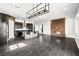 Open-concept living room features a modern fireplace and sleek gray flooring at 11800 Black Canary Ave, Las Vegas, NV 89138