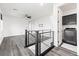 Upstairs loft features railing, wood-look floors, and a laundry room off to the side at 11800 Black Canary Ave, Las Vegas, NV 89138