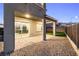A view of the covered outdoor patio and backyard, with sliding door access to indoor spaces at 11800 Black Canary Ave, Las Vegas, NV 89138