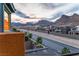 Neighborhood street view showcases modern homes with desert landscaping and stunning mountain views at 11800 Black Canary Ave, Las Vegas, NV 89138