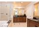 Luxurious bathroom featuring double vanity with dark wood cabinets, oversized mirror, and separate shower and tub at 125 E Harmon Ave # 2814/2816, Las Vegas, NV 89109