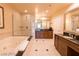 Bathroom featuring a soaking tub, dual vanities, and tile floors at 125 E Harmon Ave # 2814/2816, Las Vegas, NV 89109