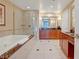 Spacious bathroom featuring dual vanities, soaking tub, and a glass-enclosed shower at 125 E Harmon Ave # 2814/2816, Las Vegas, NV 89109