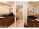 Bright bathroom with dual vanities, dark granite countertops, and a separate toilet room for added privacy at 125 E Harmon Ave # 2814/2816, Las Vegas, NV 89109