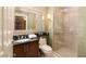 Bathroom featuring wood vanity, toilet, mirror, and glass shower at 125 E Harmon Ave # 2814/2816, Las Vegas, NV 89109