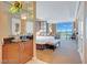 Bedroom featuring a king-sized bed, seating area, and a bar area with a view of the city at 125 E Harmon Ave # 2814/2816, Las Vegas, NV 89109