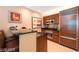 Well-equipped kitchen featuring modern appliances, granite countertops, rich wooden cabinetry, and a breakfast bar at 125 E Harmon Ave # 2814/2816, Las Vegas, NV 89109