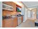 A convenient kitchenette featuring stainless steel appliances, granite countertops, and custom cabinetry at 125 E Harmon Ave # 2814/2816, Las Vegas, NV 89109
