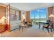 Bright living room featuring a comfortable seating area and expansive city views through large windows at 125 E Harmon Ave # 2814/2816, Las Vegas, NV 89109