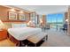 A luxurious king-sized bed with bench and convenient seating area offering exceptional city views at 125 E Harmon Ave # 2814/2816, Las Vegas, NV 89109
