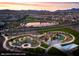 Panoramic aerial view of the community showcasing a lake, playground, walking paths, and mountain views at 147 Harmonica Ave # Lot 24, Henderson, NV 89015