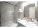 Bathroom with marble tiled shower and a white sink at 1511 Living Desert Dr # C, Las Vegas, NV 89119