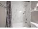 Updated bathroom with bathtub, shower with marble-patterned walls, and toilet at 1511 Living Desert Dr # C, Las Vegas, NV 89119