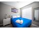 Cozy bedroom with blue linens and a large window providing natural light at 1511 Living Desert Dr # C, Las Vegas, NV 89119